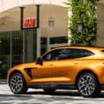 Orange Aston Martin DBX parked outside H&M
