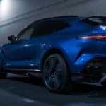Blue 2023 Aston Martin DBX707 driving through a tunnel