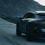2023 Aston Martin DBX driving on mountain highway