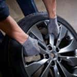 Mechanic dragging a tire