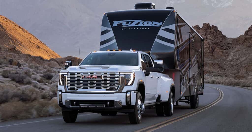 GMC Sierra 2500 HD towing a trailer on the road
