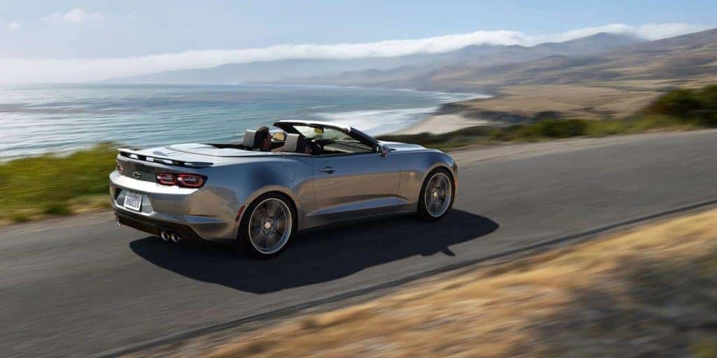 2022 Chevy Camaro with the top down drives along the coast.
