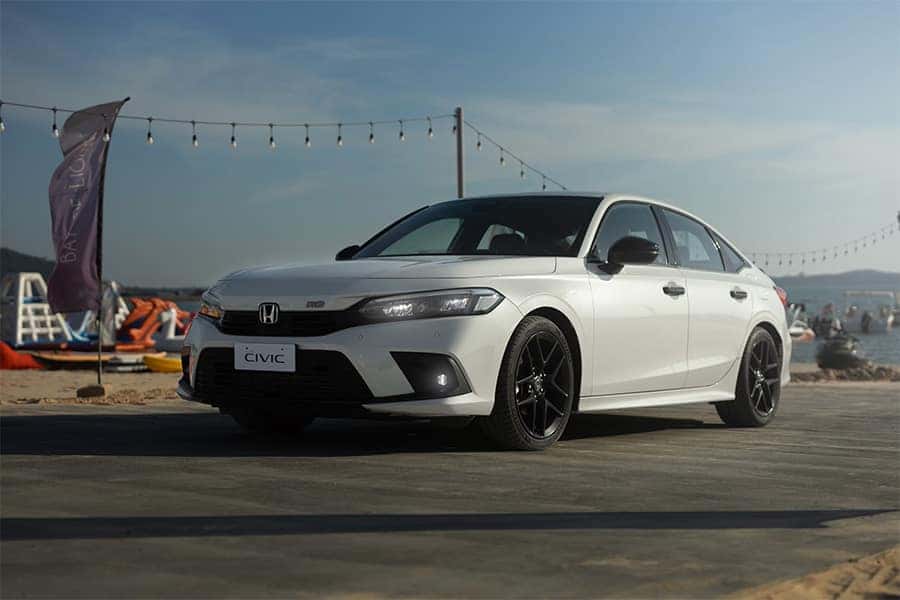 CPO white Honda Civic parked on the beach