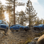ubaru Wilderness lineup — Subaru Forester, Outback, and Crosstrek parked on a rocky forest trail at sunset, showcasing off-road capability.