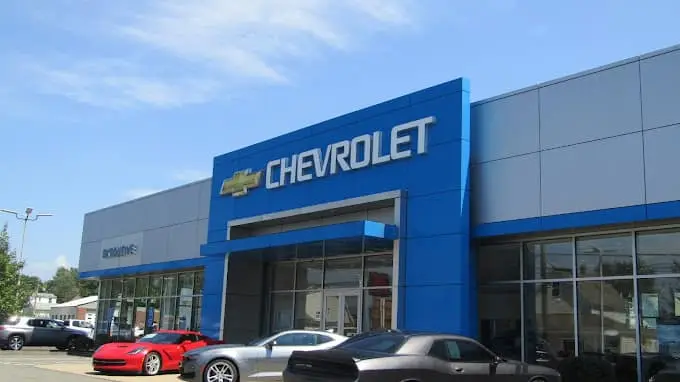 An exterior shot of a Chevrolet dealership at night.