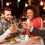 Friends are eating outdoors at night at a restaurant in Atlanta, GA.