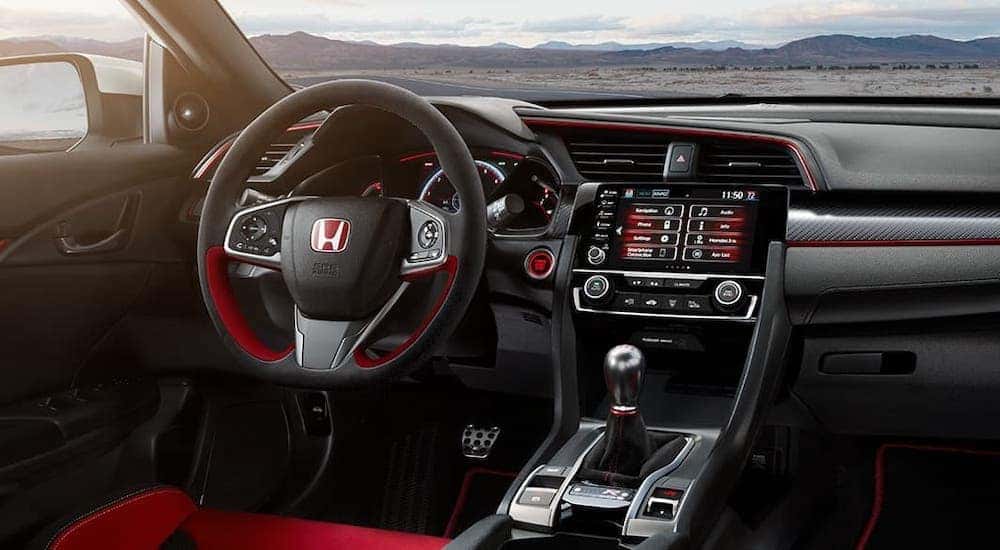 The black interior with red accents of a 2021 Honda Civic Type R is shown.