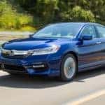 A blue 2017 Honda Accord is driving past a white fence near Duluth, GA.