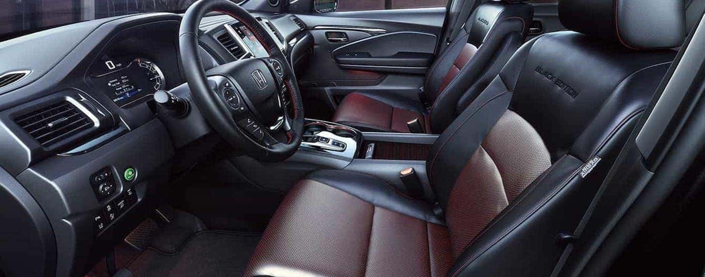 The black and red front seats in a 2020 Honda Ridgeline Black Edition are shown from the side.