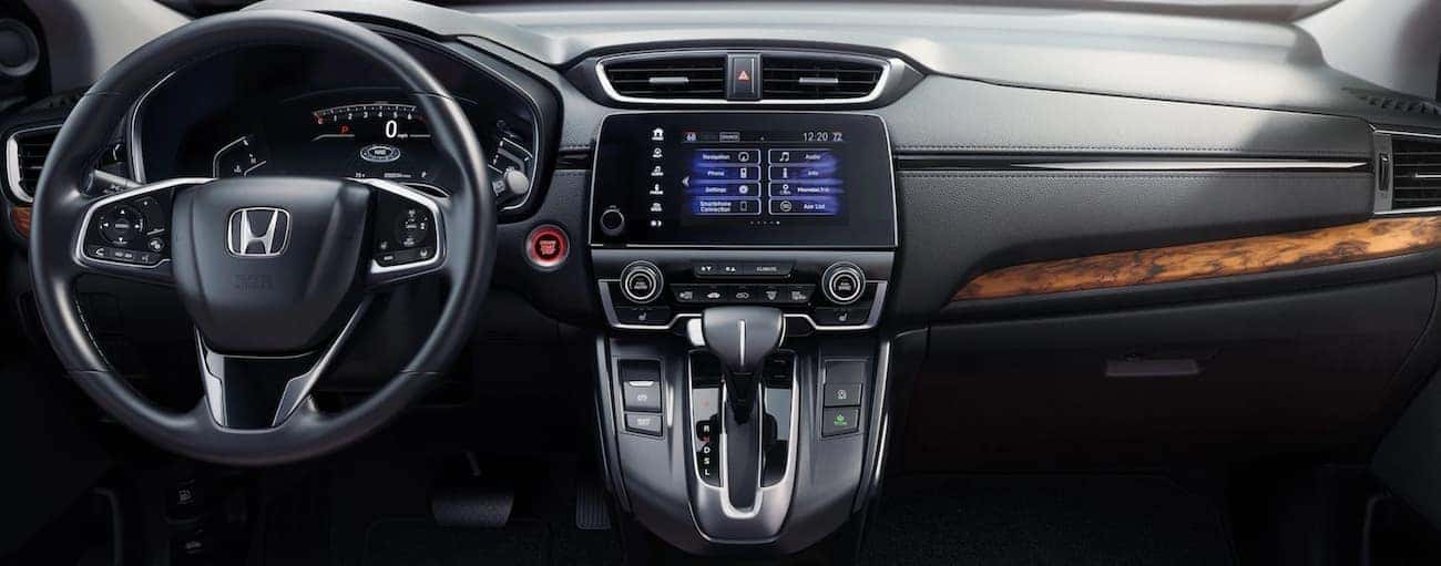 The dashboard and infotainment screen are shown in a 2021 Honda CR-V Touring.