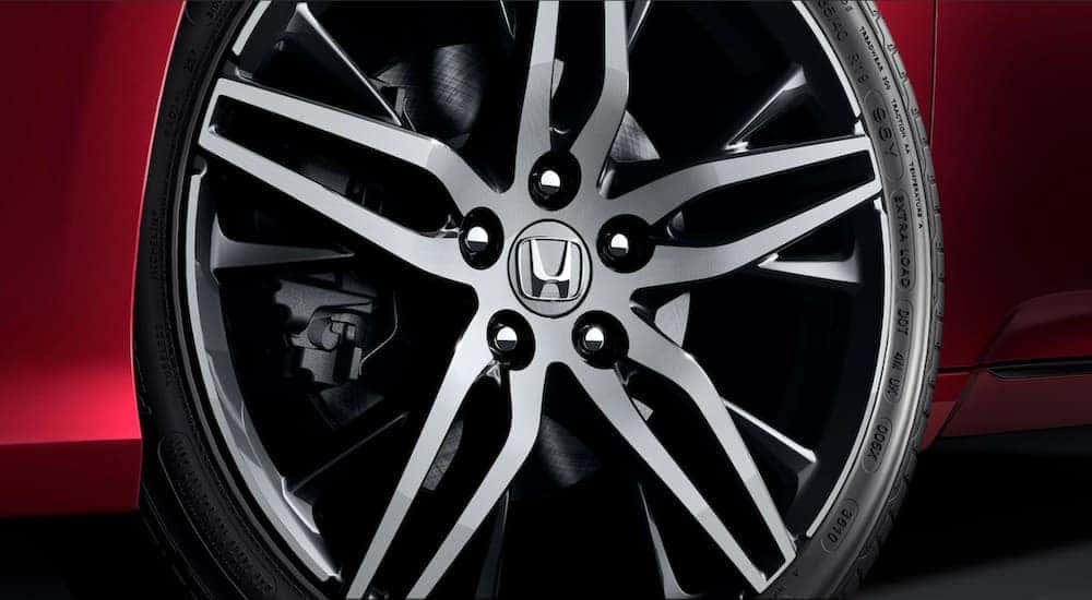 A close up shows the wheel on a red 2019 Honda Accord.