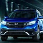 A blue 2022 Honda CR-V Touring is shown from the front driving through a tunnel after leaving an Atlanta Honda CR-V dealer.