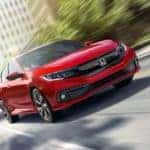A red 2019 Honda Civic is shown speeding on a city street.