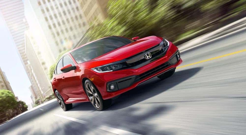 A red 2019 Honda Civic is shown speeding on a city street.