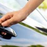 A person is shown opening a car door.