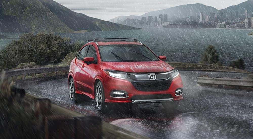 A red 2020 Honda HR-V is shown from the front after leaving a dealer that has used Honda SUVs for sale.
