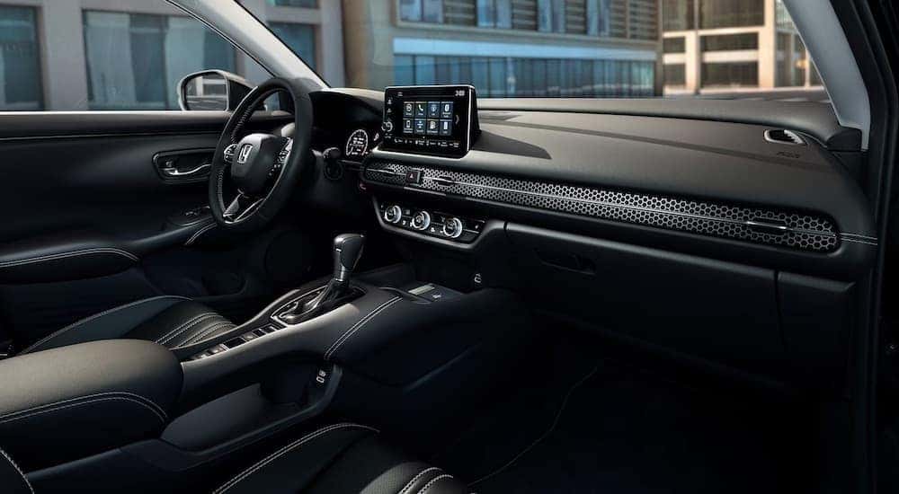 The black interior of a 2023 Honda HR-V is shown from the passenger side.