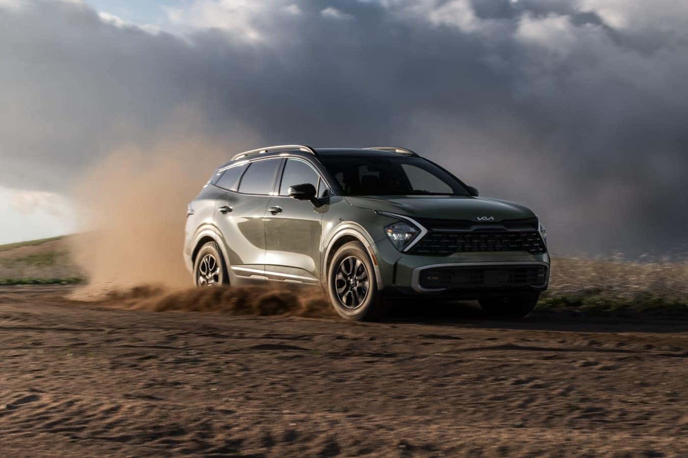 Green 2025 Kia Sportage on a dirt road