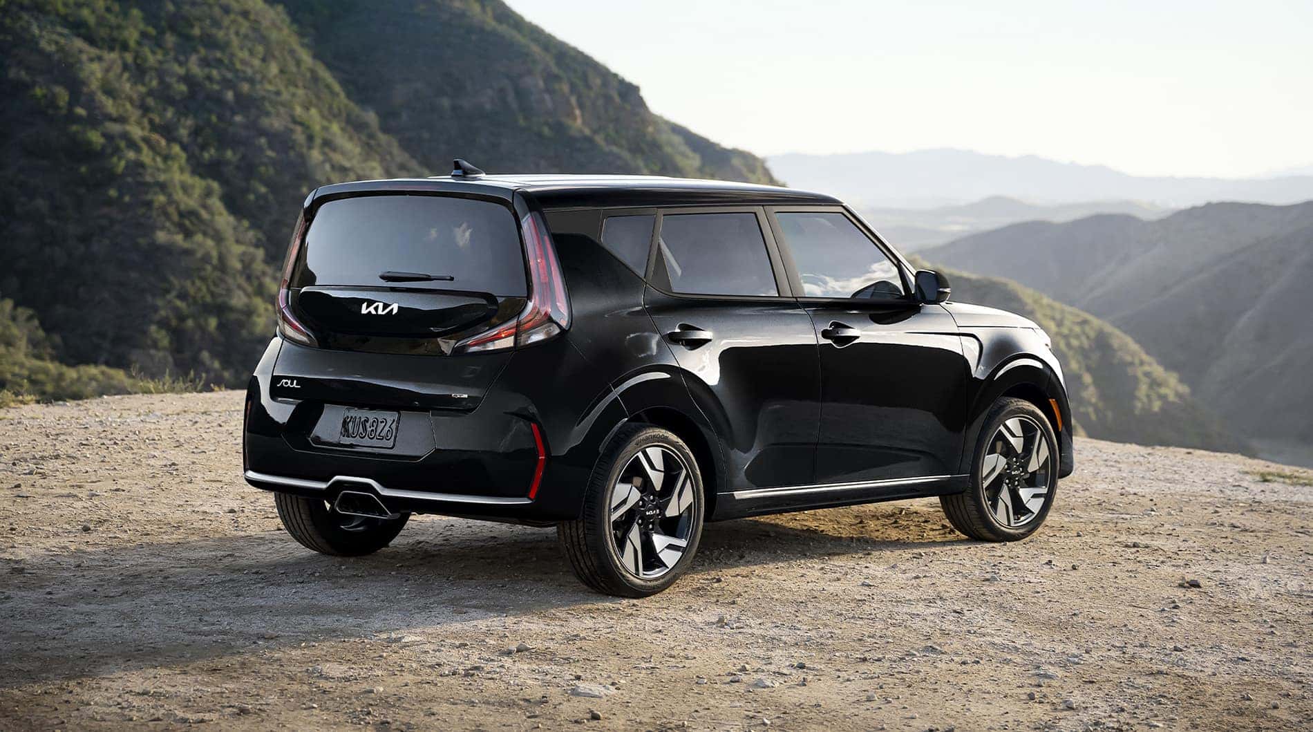A picture of a black 2025 Kia Soul parked and overlooking a mountain pass.