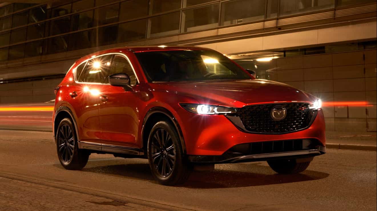 Red CX-5 driving at night.