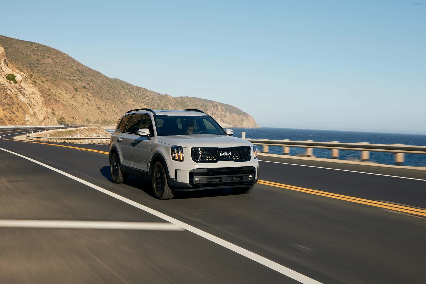 Grey Kia Telluride driving down the highway