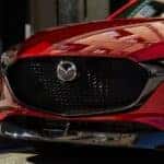 Front grill of a red Mazda3