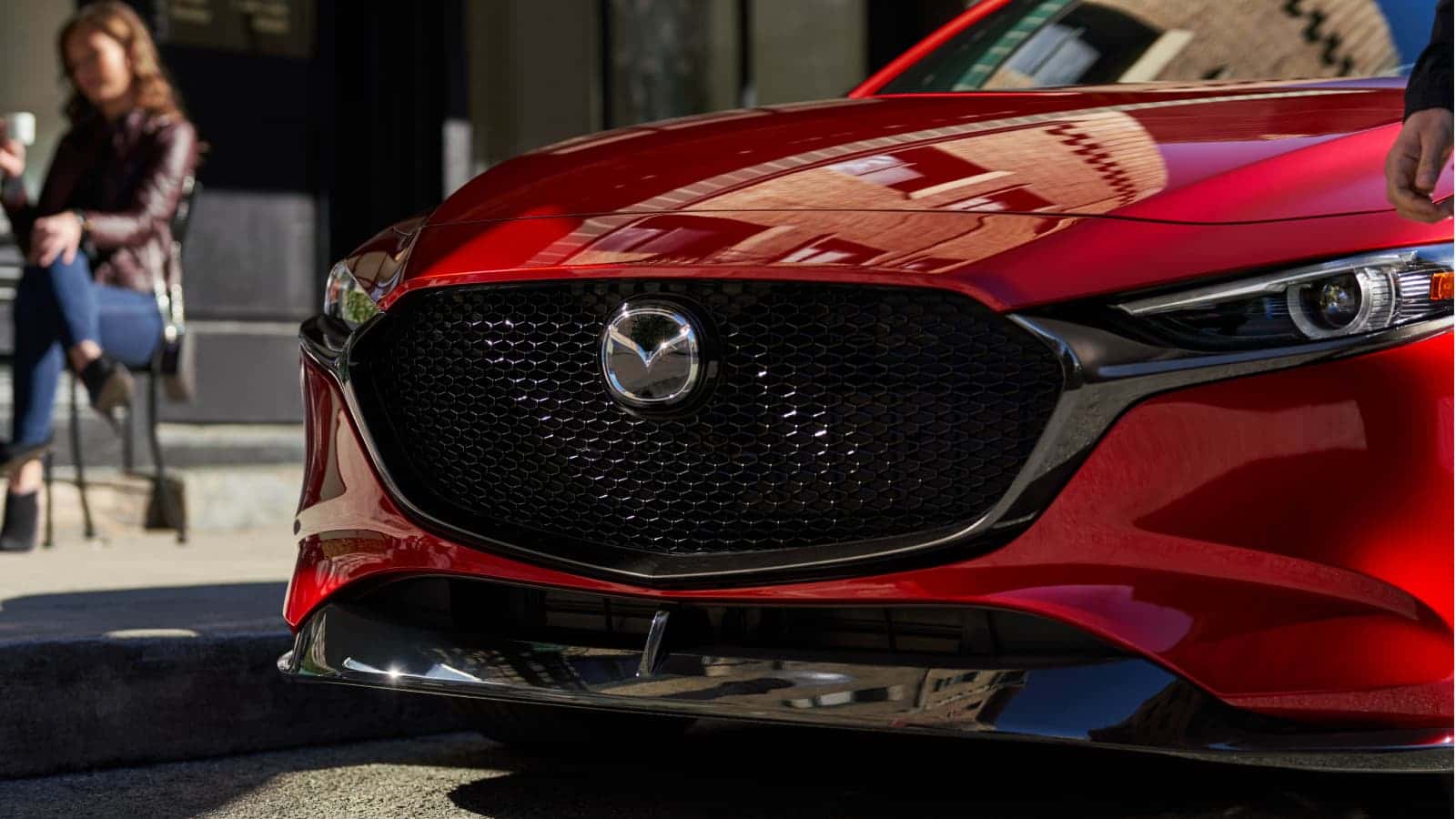 Front grill of a red Mazda3