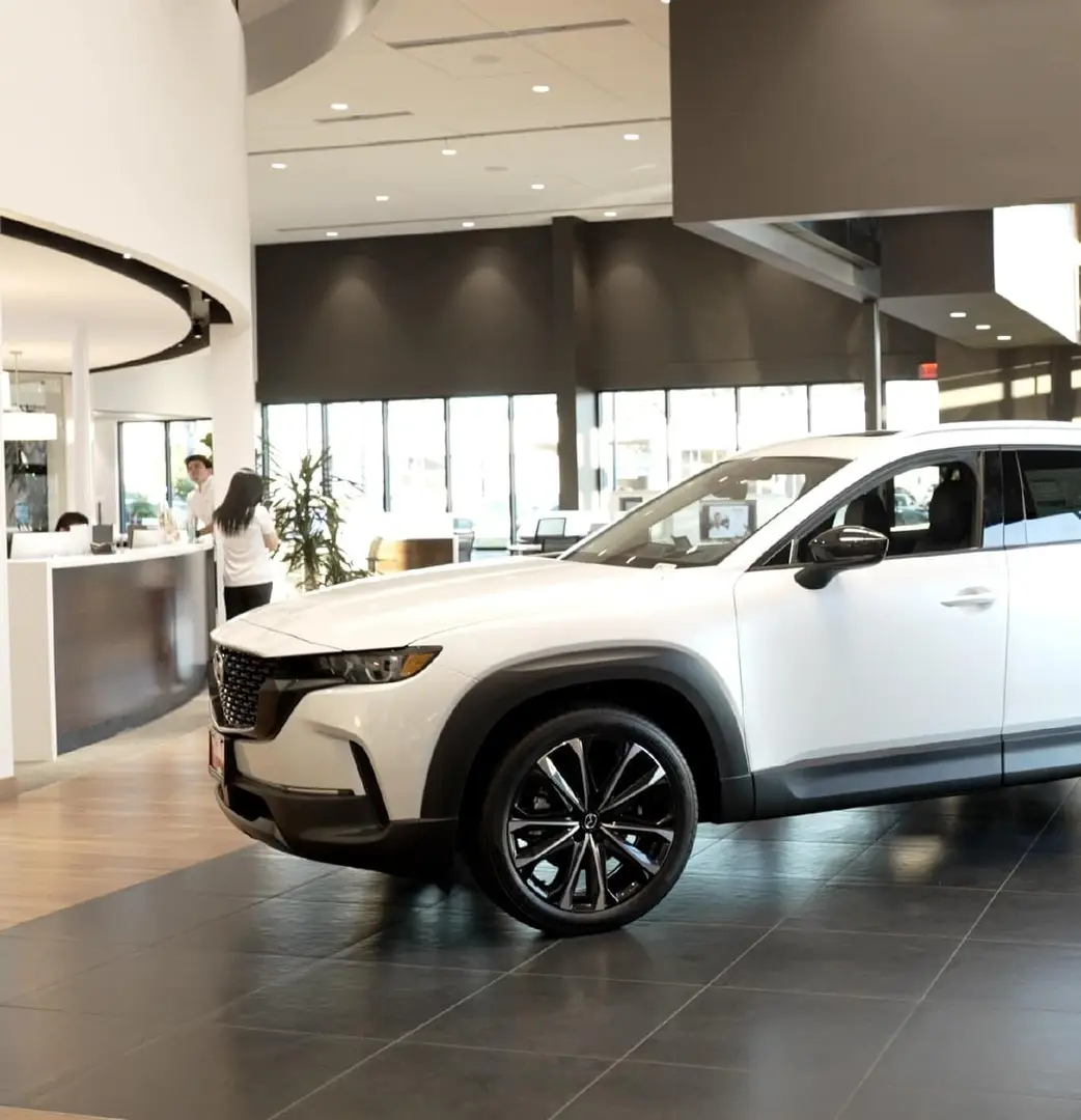 woman walking toward parked Mazda Crossover