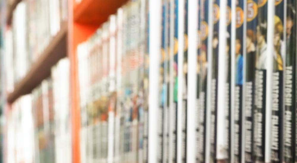 Blurry view of a shelf displaying comic books