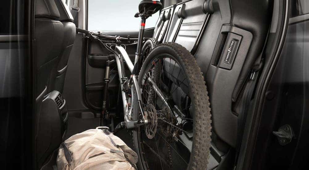 A bicycle in the backseat of a 2021 Honda Ridgeline RTL-E with a black interior