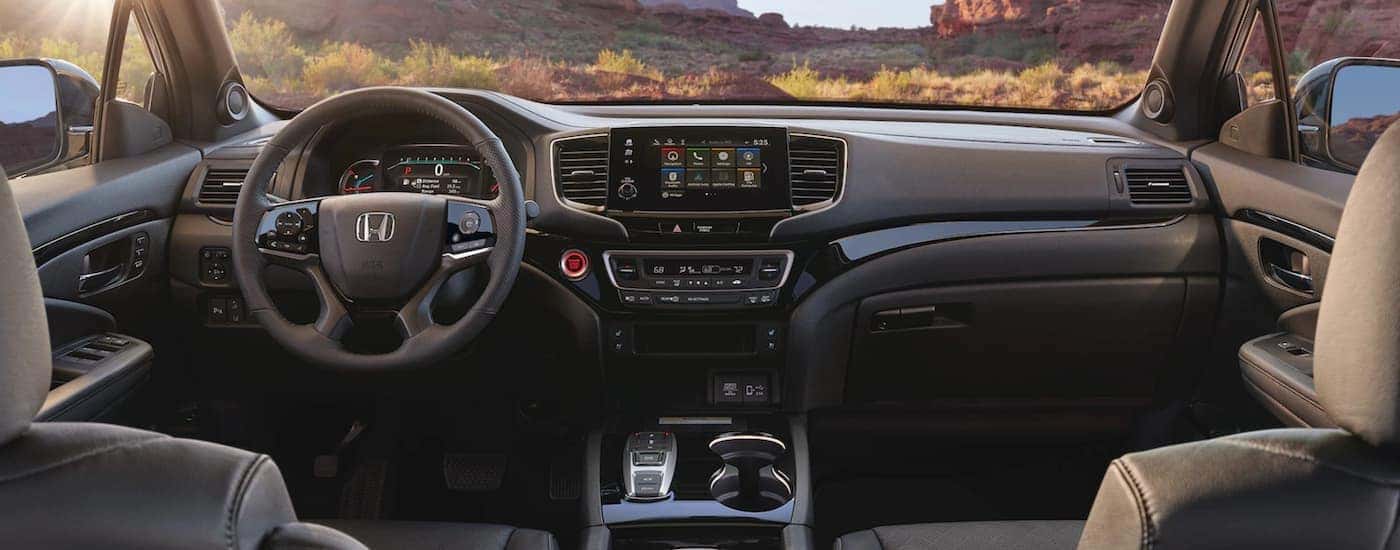 Steering wheel, infotainment center, and dashboard of a 2021 Honda Passport Elite