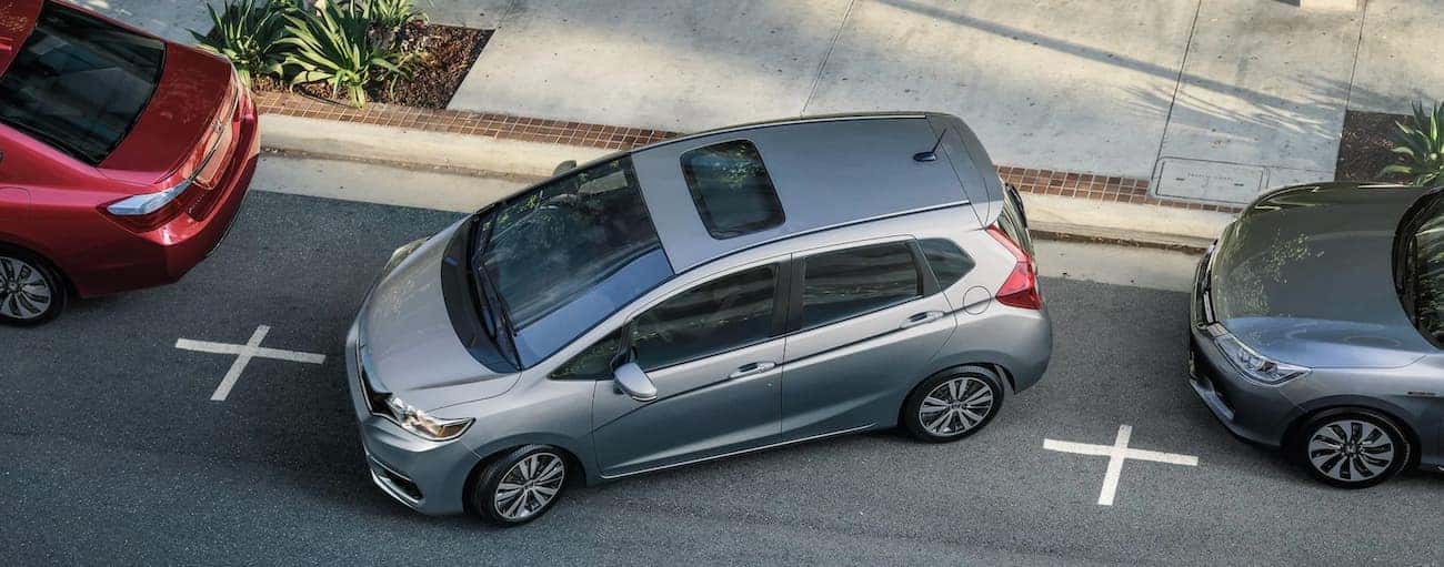 A silver 2020 Honda Fit EX-L is shown from a high angle parallel parking.