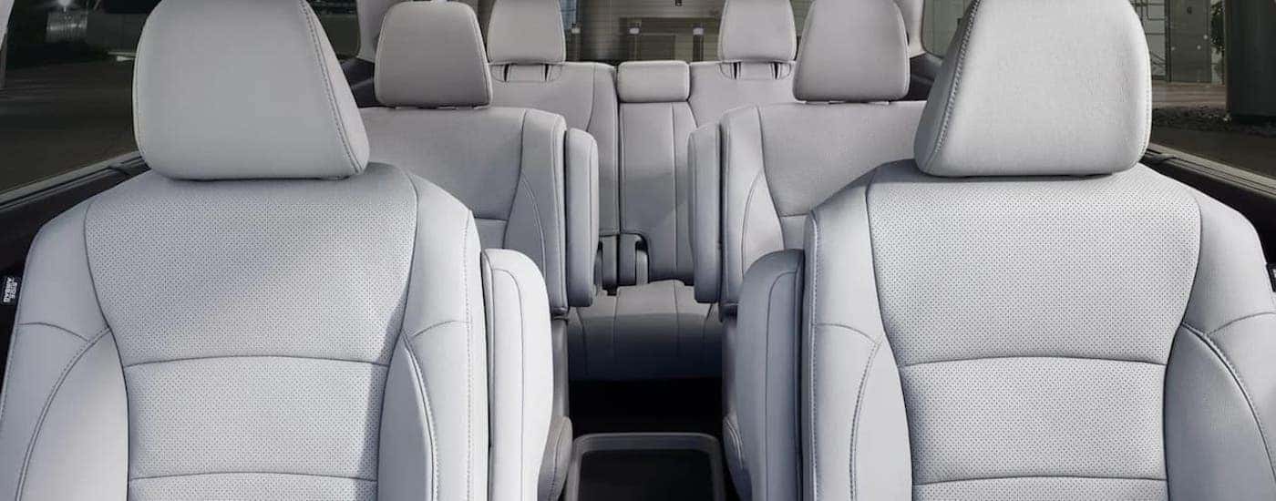 Three rows of light grey cloth seating inside a 2020 Honda Pilot