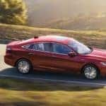A red 2022 Honda Insight is shown from the side after leaving a Fayetteville Honda dealership.