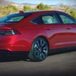 A red 2023 Honda Accord is shown from the rear at an angle after leaving a dealer that has cars for sale.