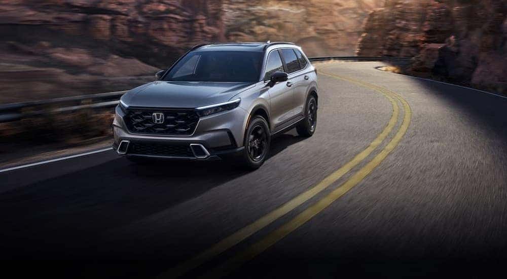 A silver 2022 Honda CR-V is shown driving on a highway.