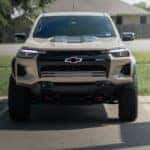 White Chevy Colorado truck parked on the side of a road
