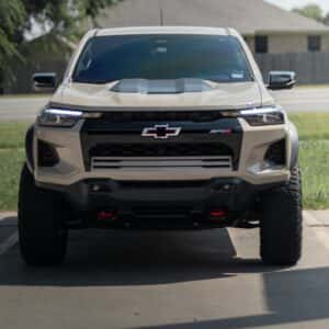 White Chevy Colorado truck parked on the side of a road