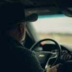 Man in hat driving