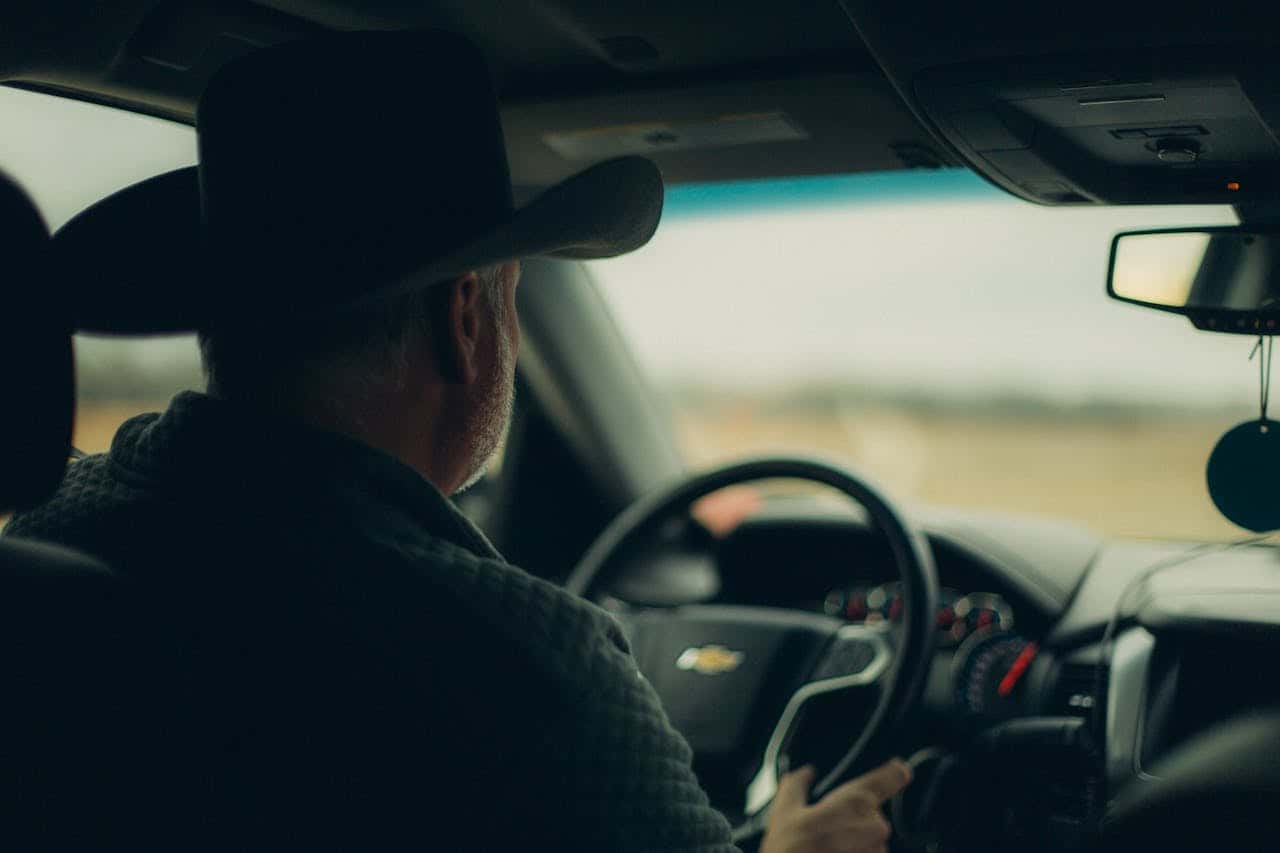 Man in hat driving