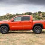 2026 Nissan Frontier PRO-4X In a open field, interior is a bright orange