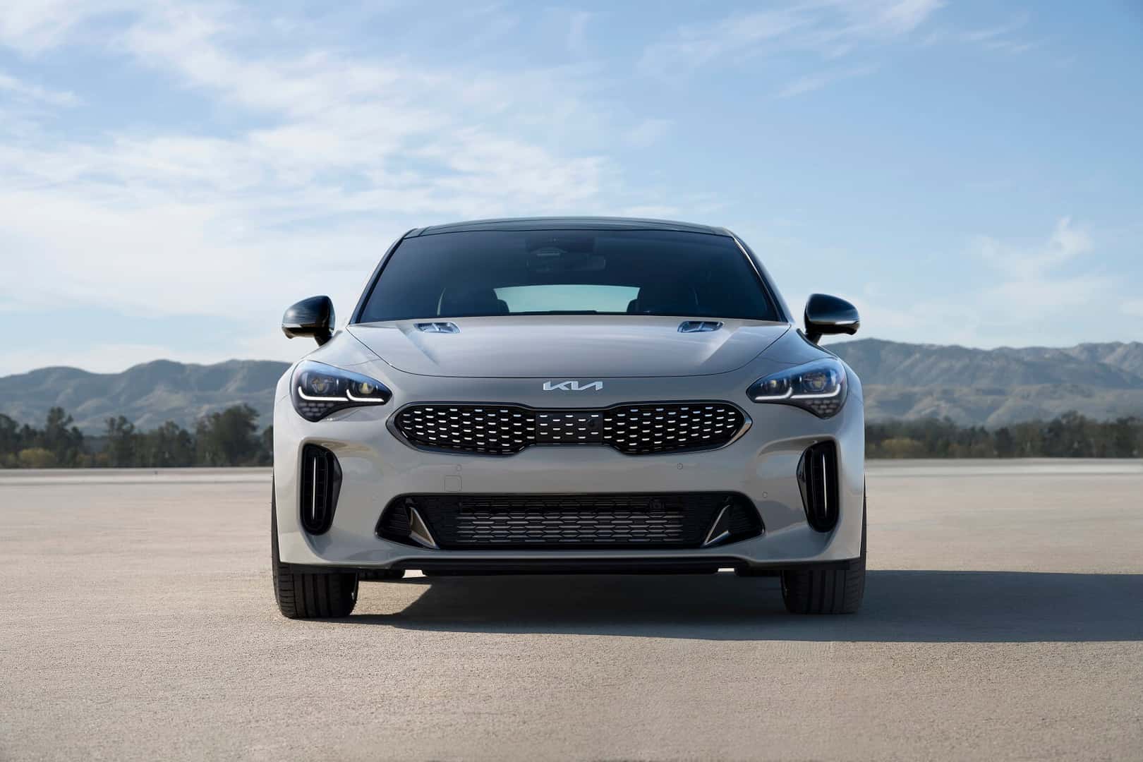 Pre-Owned Kia Stinger parked in front of mountain range