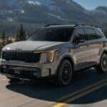 Grey 2026 Kia Sorento driving on mountain road