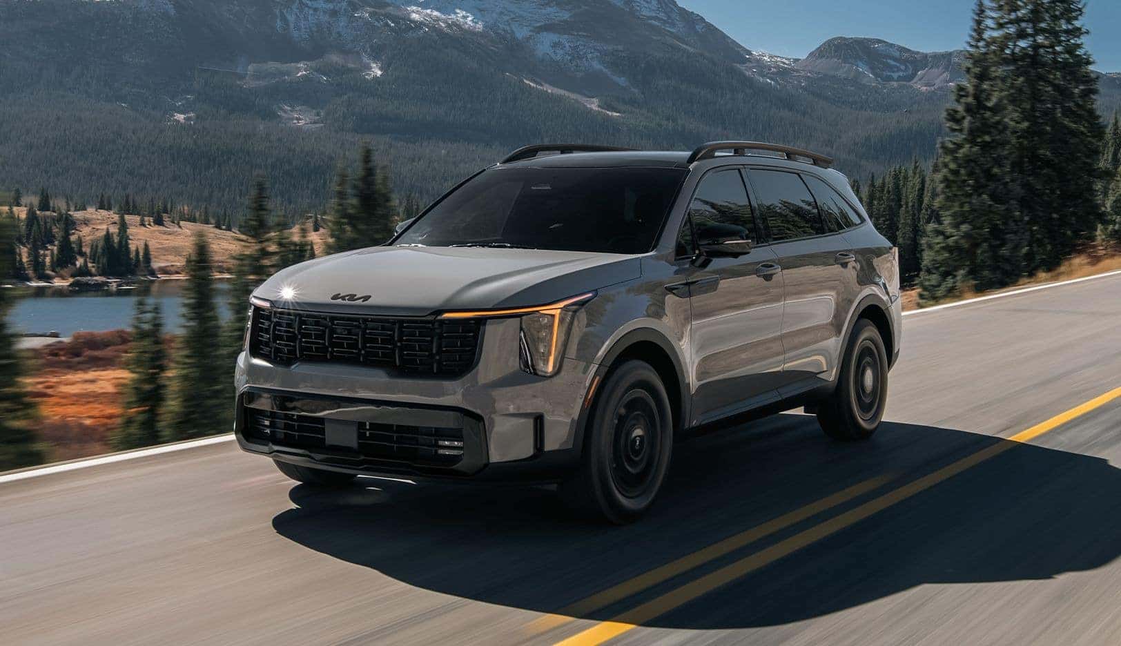 Grey 2026 Kia Sorento driving on mountain road