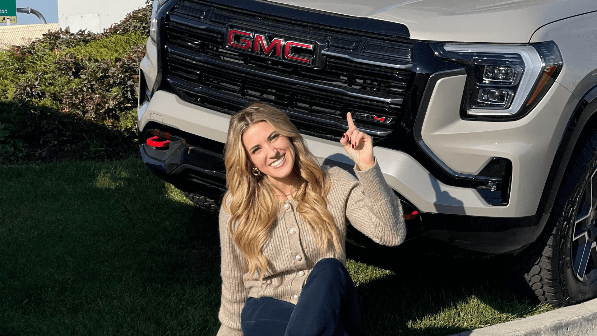A blonde woman pointing up