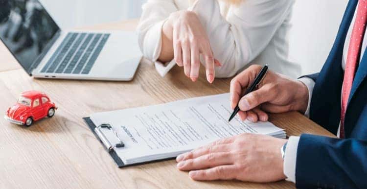 Person writing on clip board