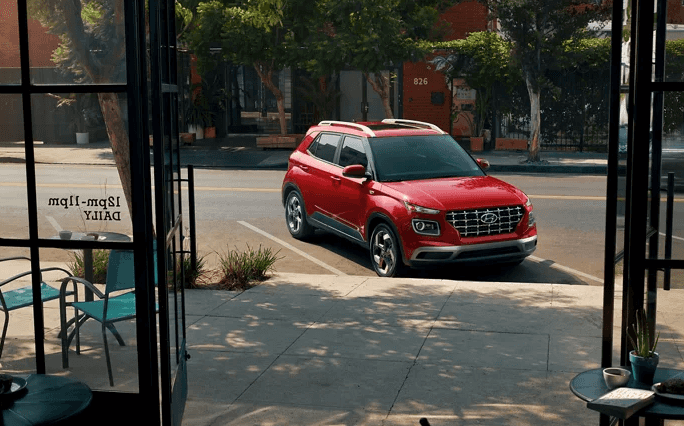 Red 2026 Hyundai Venue parked outside of shop availible at O'brien Hyundai of Normal.