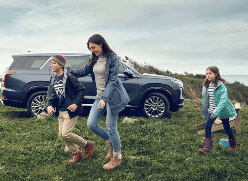 New Hyundai Warranty Coverage Car with family in field.