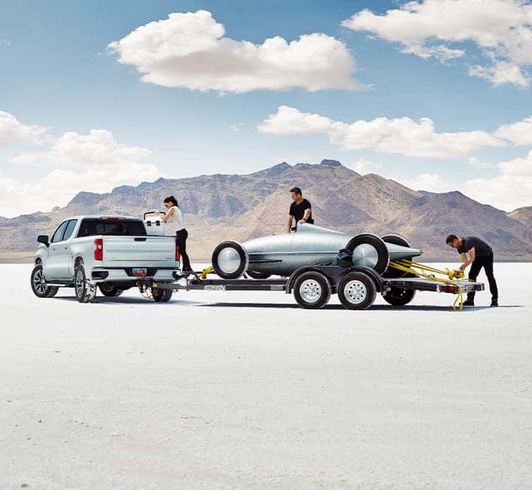 The 2022 Chevrolet Silverado 1500 at Performance Chevrolet | Loading Go Cart Onto Trailer Attached to Back of White Silverado