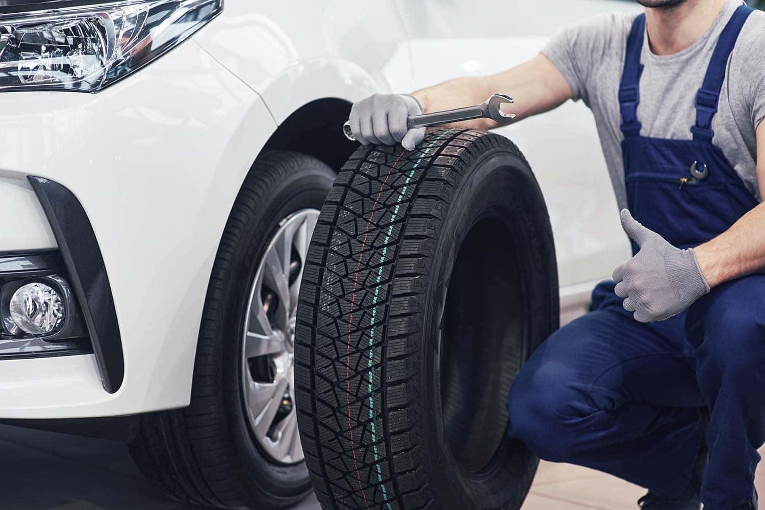 How to check your tires' health at Performance Chevrolet | Service technician showing a brand new tire